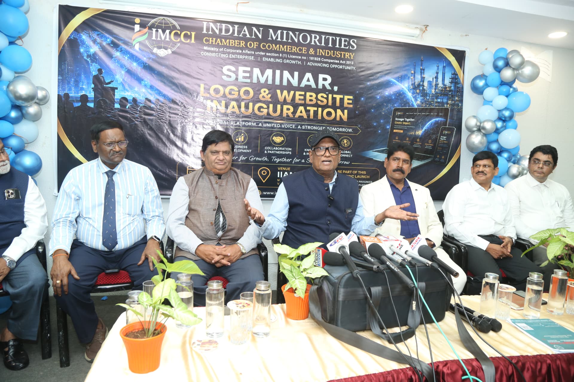 IMCCI speaker addressing assembled microphones during the press interaction