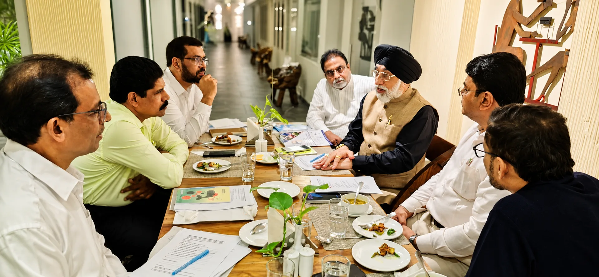 IMCCI leadership group seated around a conference table in strategic discussion