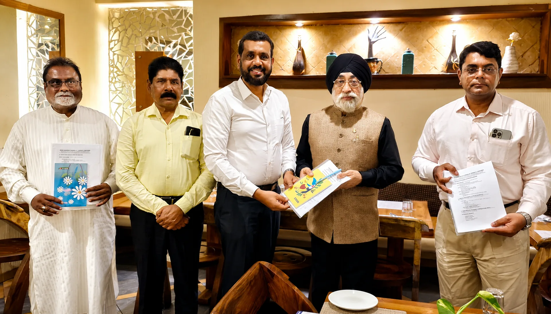 IMCCI leadership presenting official documents and programme material together